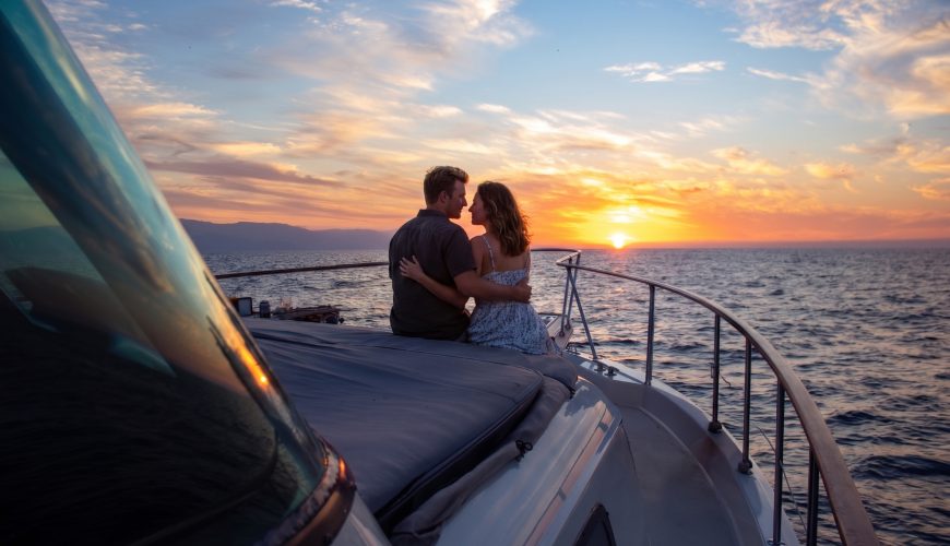 Couple embracing on a luxury yacht during a sunset proposal in Puerto Vallarta.