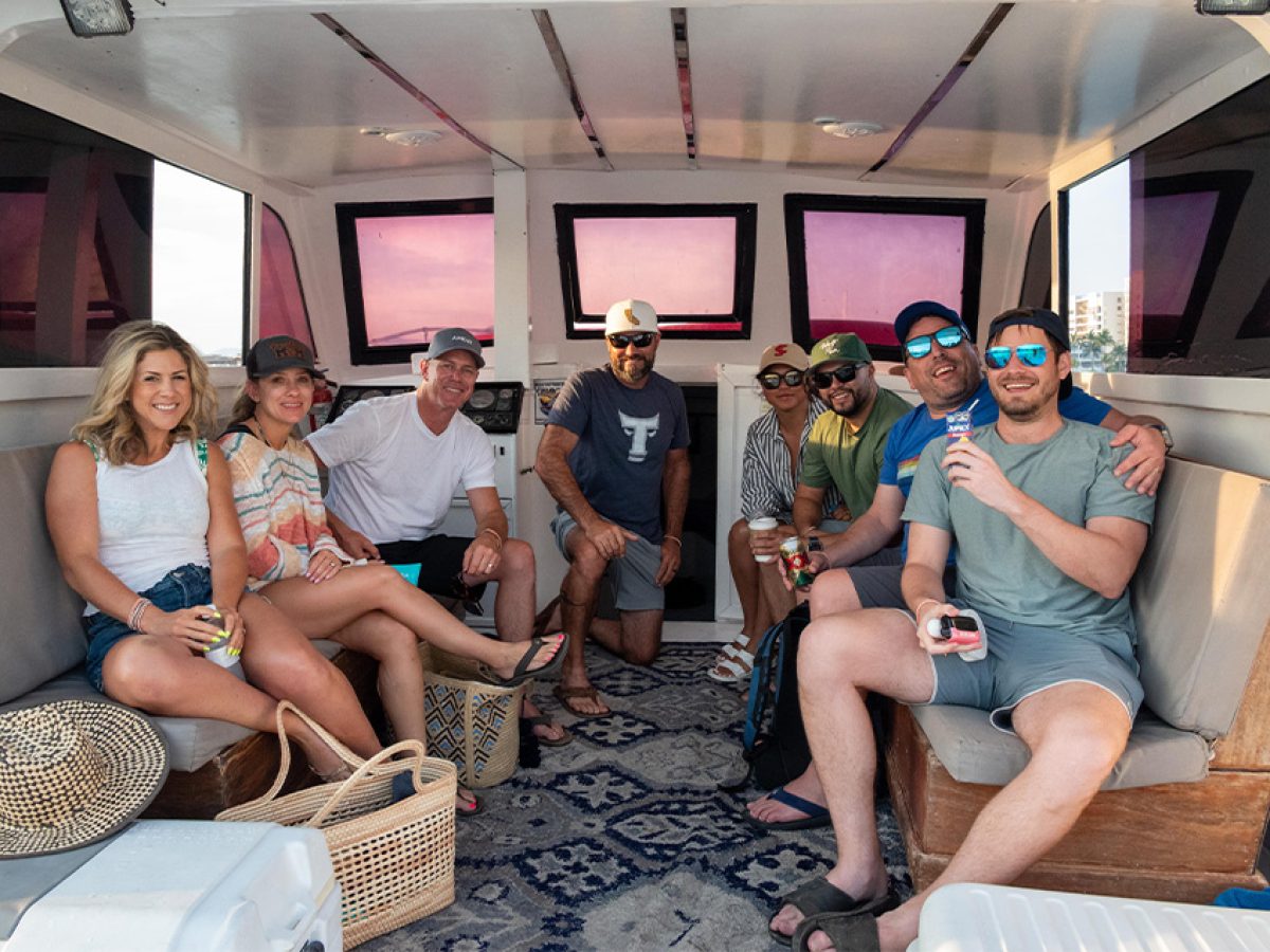 Friends happily crowded inside a private boat in Puerto Vallarta.