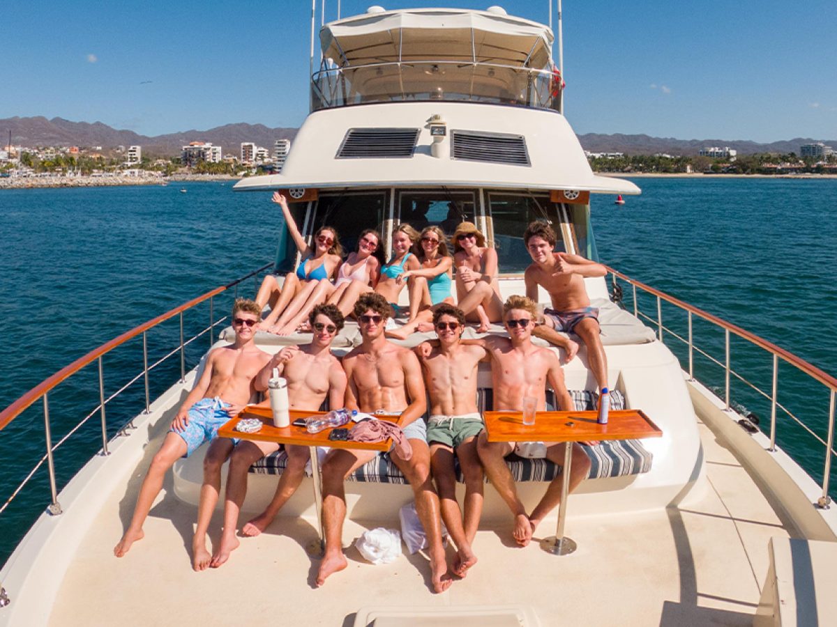 Wide shot of a group of friends enjoying a private yacht charter in Puerto Vallarta.