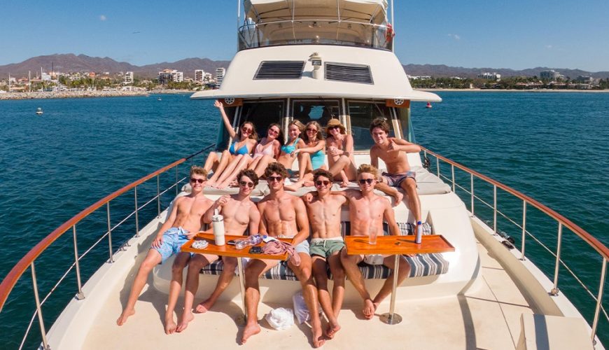 Wide shot of a group of friends enjoying a private yacht charter in Puerto Vallarta.