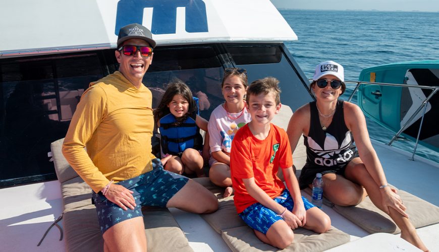 Family smiling on a sportfishing boat tour in Puerto Vallarta without seasickness.
