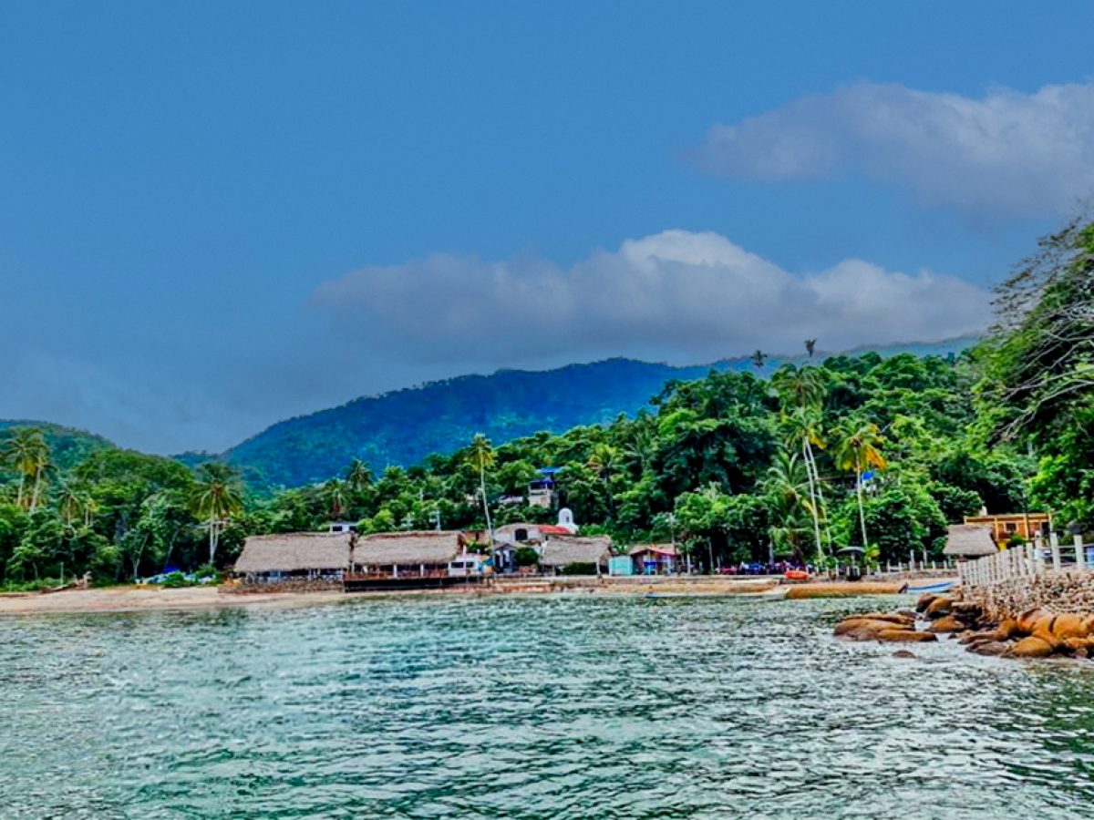 Scenic view of Quimixto beach with golden sands and calm ocean waters in Puerto Vallarta.
