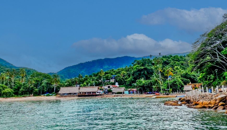 Scenic view of Quimixto beach with golden sands and calm ocean waters in Puerto Vallarta.