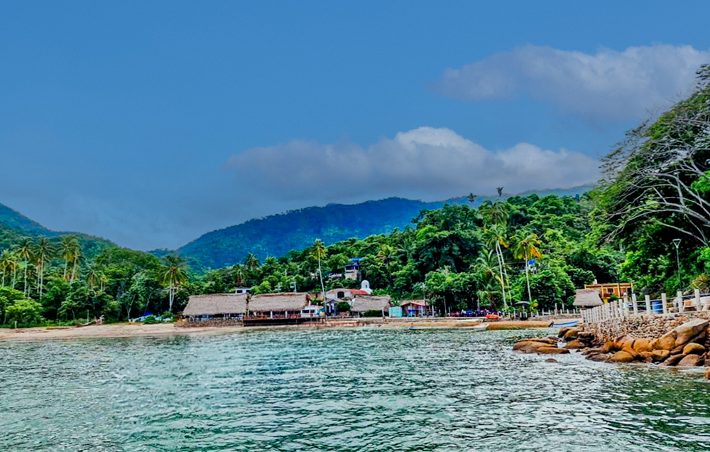 Scenic view of Quimixto beach with golden sands and calm ocean waters in Puerto Vallarta.