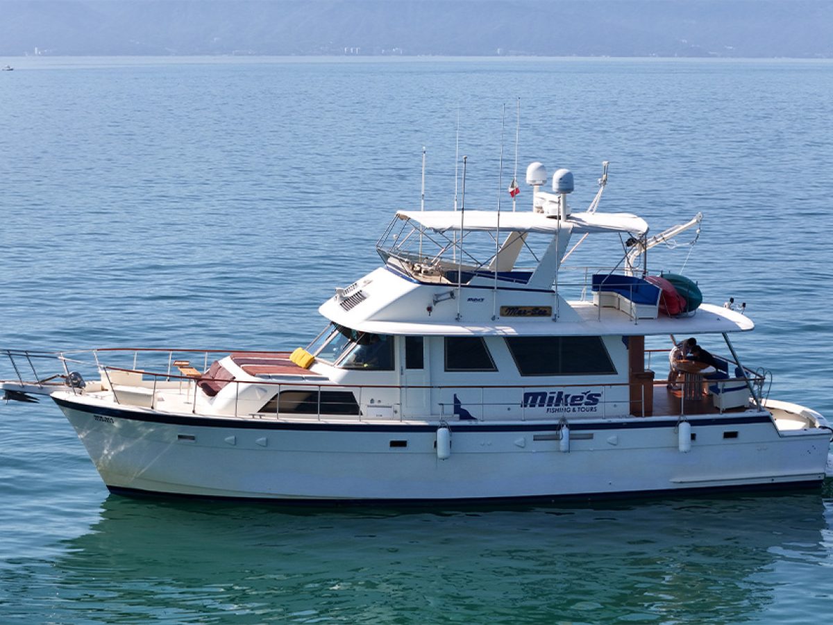 Mer Sea Hatteras 61 foot luxury yacht anchored in clear blue waters in Puerto Vallarta.