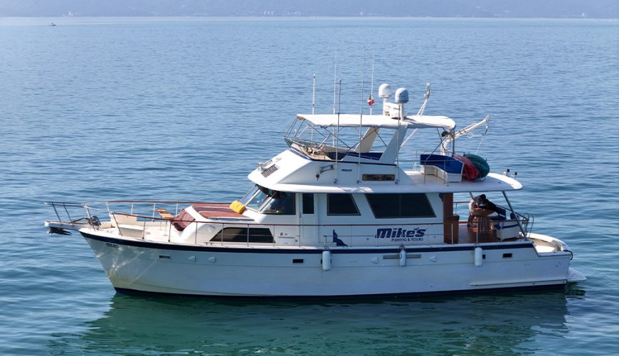 Mer Sea Hatteras 61 foot luxury yacht anchored in clear blue waters in Puerto Vallarta.