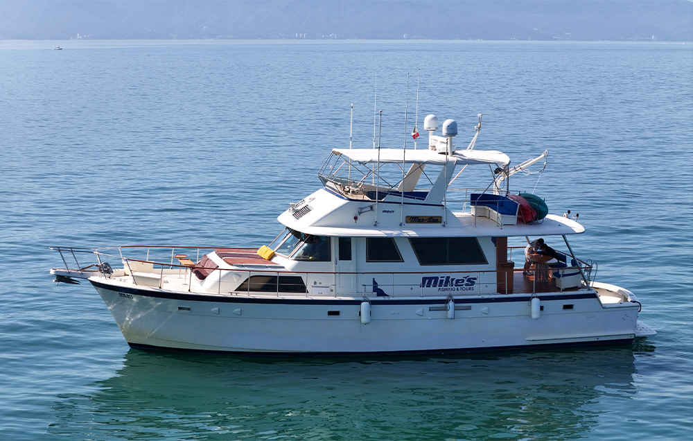 Mer Sea Hatteras 61 foot luxury yacht anchored in clear blue waters in Puerto Vallarta.