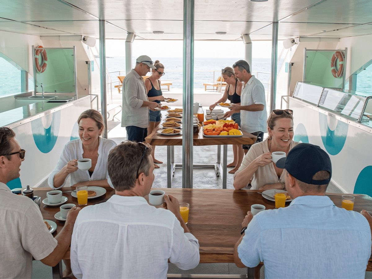 Continental breakfast with paninis and hot pancakes served on a whale watching tour deck.
